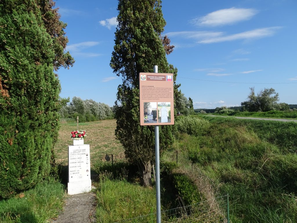 Via Piaggione: cippo eretto in memoria delle persone qui temporaneamente sepolte dopo la strage. Si noti la segnaletica del Percorso della Memoria